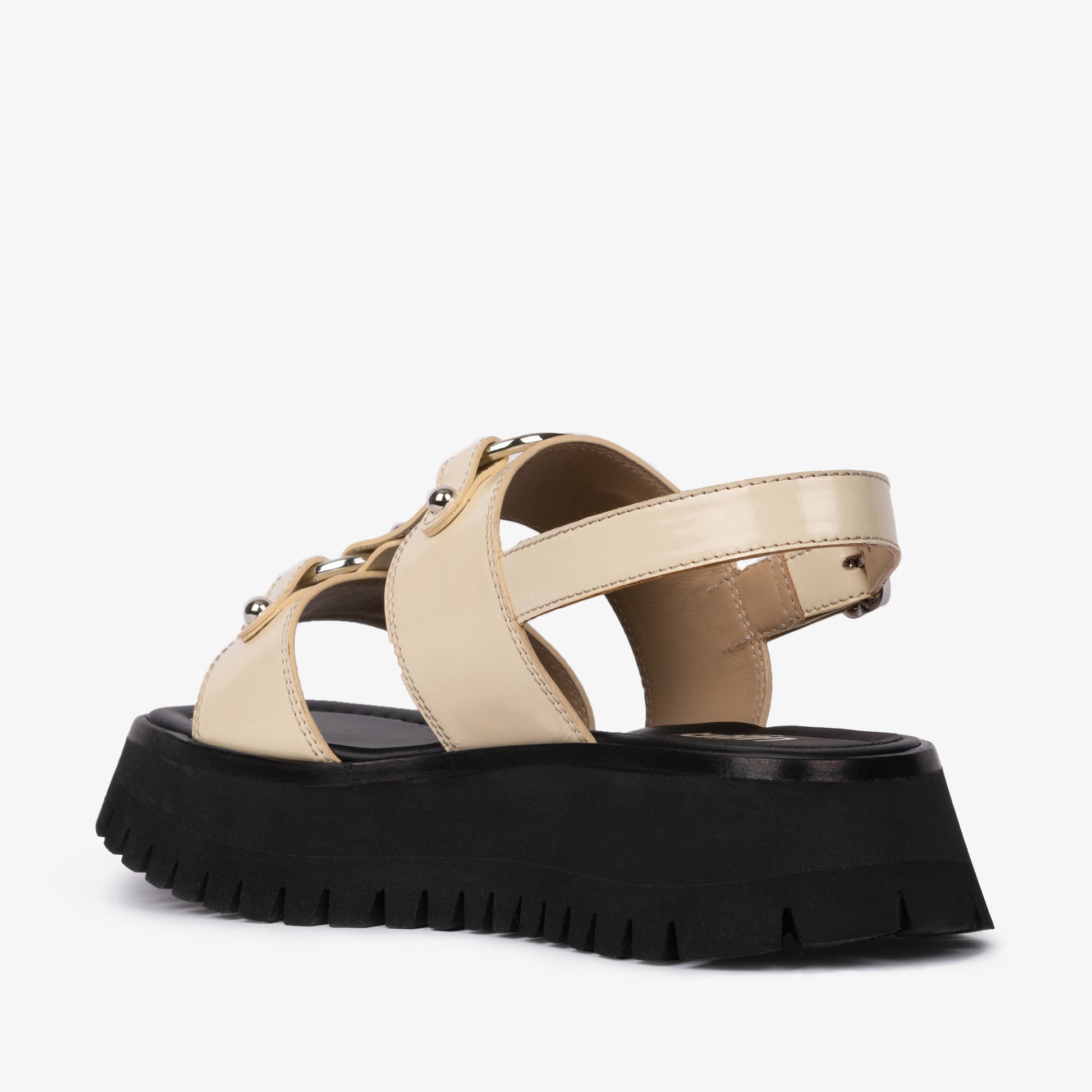 Atlas Sandal Ivory sandal displayed against product photography