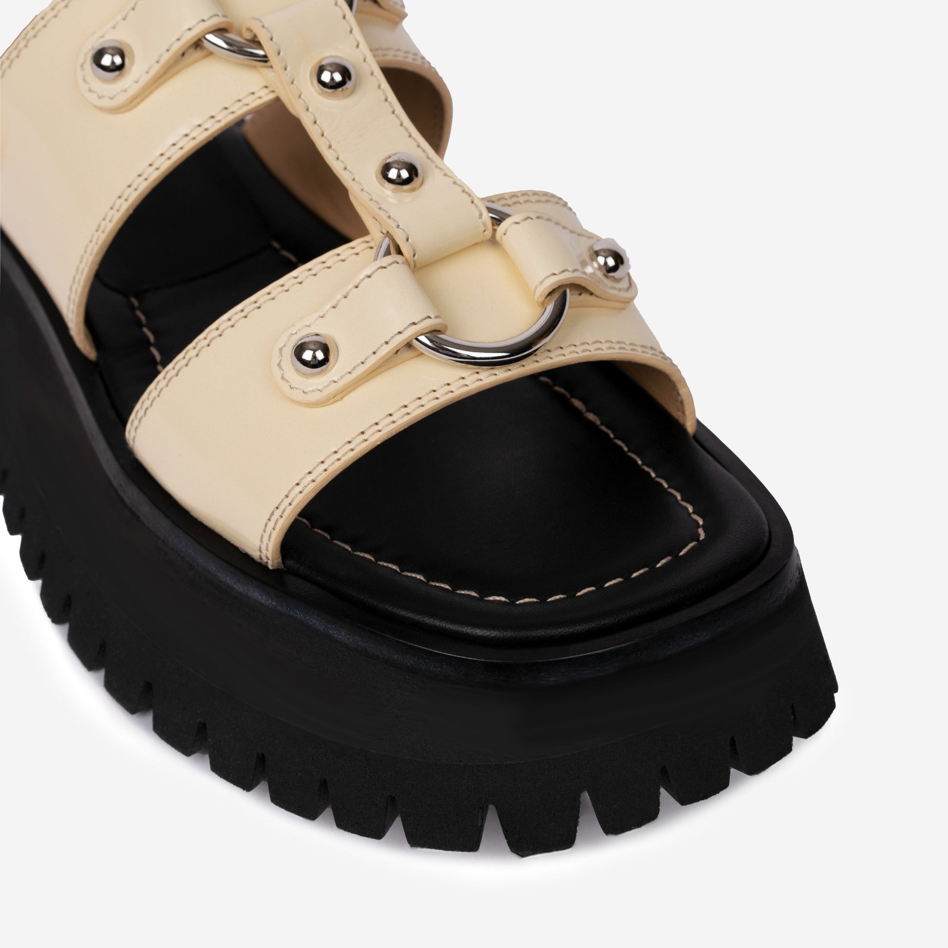 Atlas Sandal Ivory sandal displayed against product photography