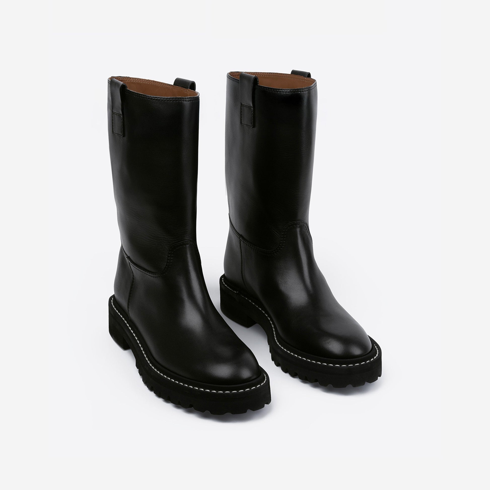 Pair of black leather boots with a rubber outsole on a white background