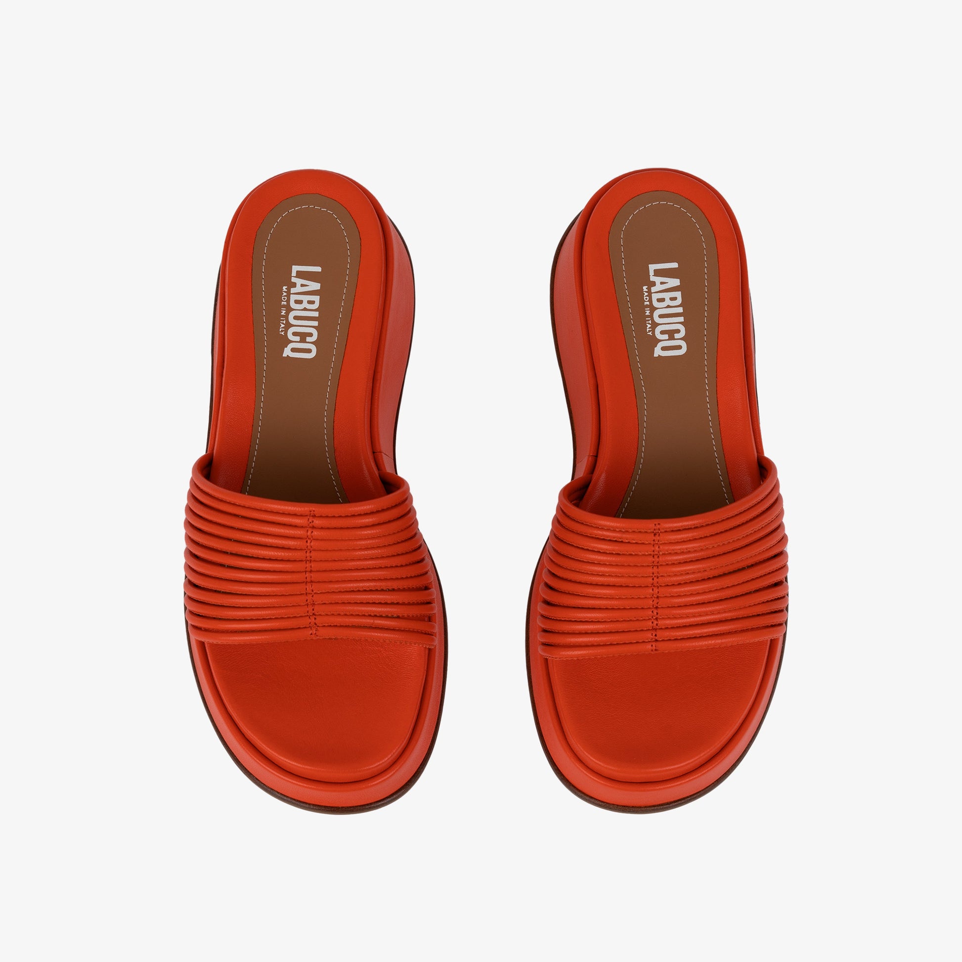 Caye Slide Tangerine in black product against studio photography