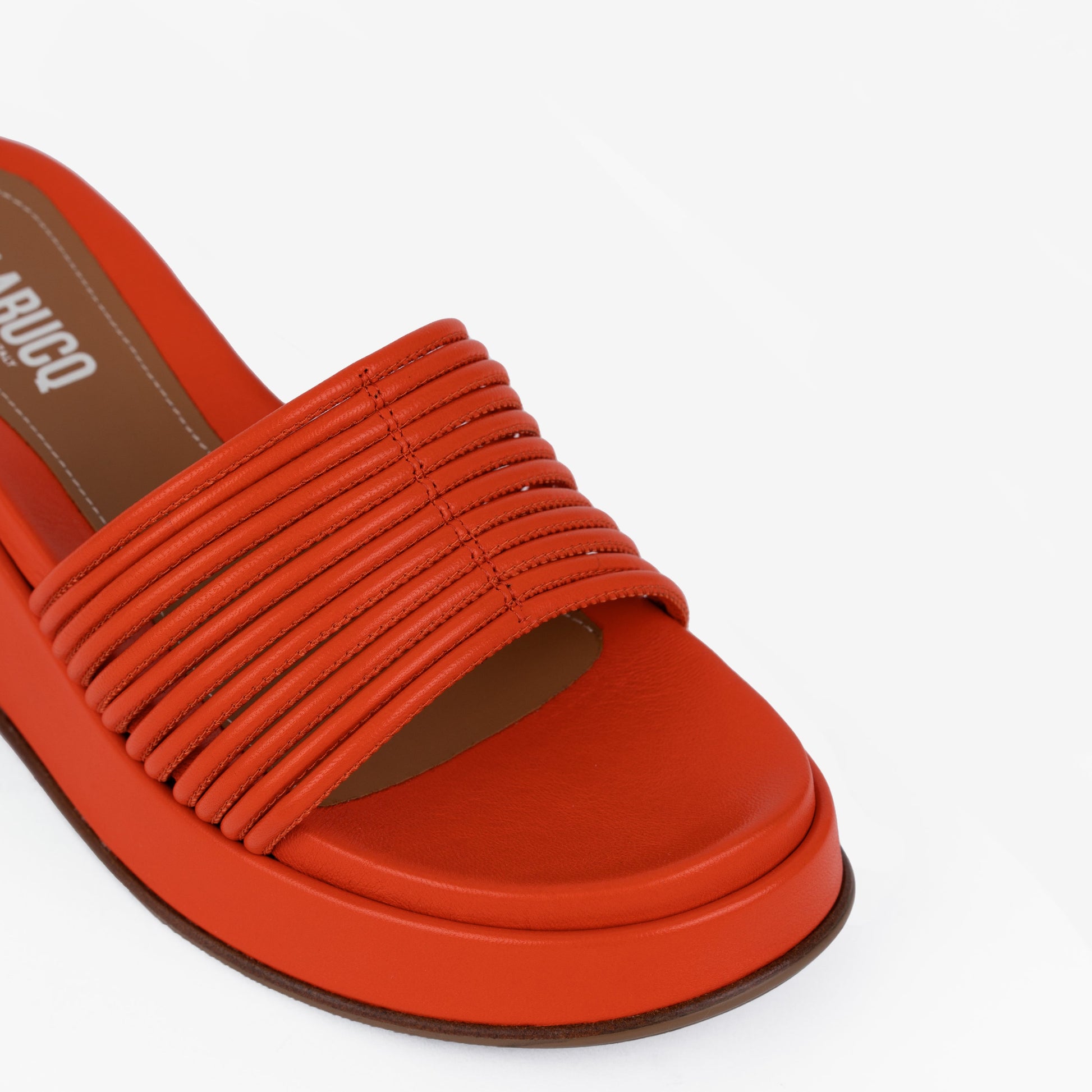 Caye Slide Tangerine sandals in tan and brown leather and suede, set against a clean background.
