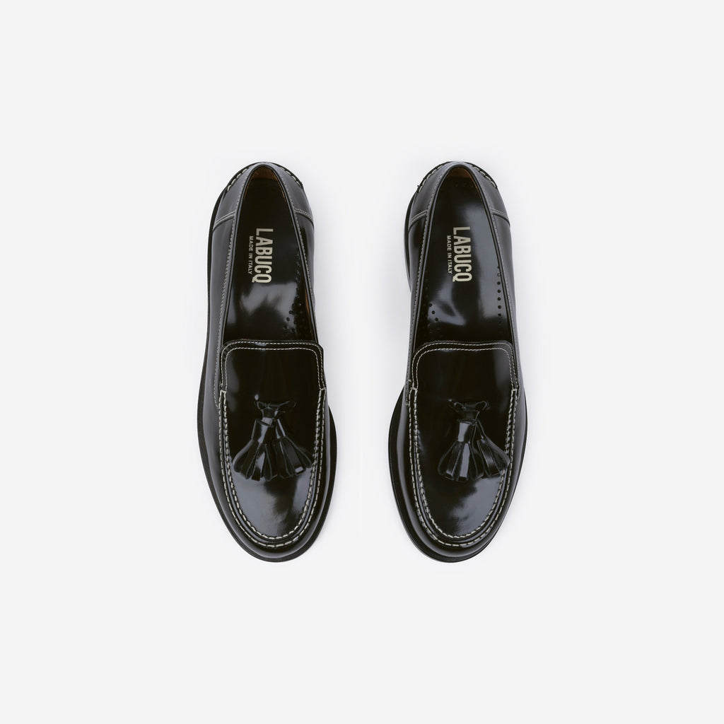 Pair of black loafers with tassels, featuring the Labucq logo, on a white background