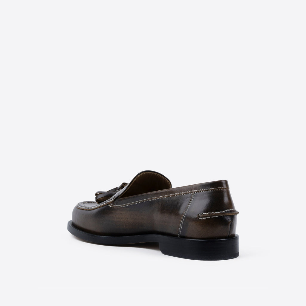 Brown leather loafer on a white background