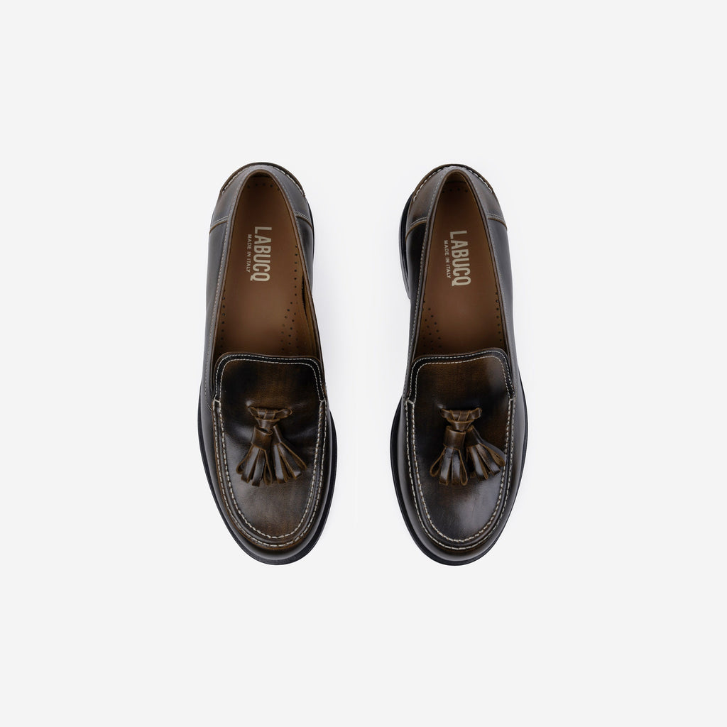 Pair of brown loafers with tassels, featuring the Labucq logo, on a white background