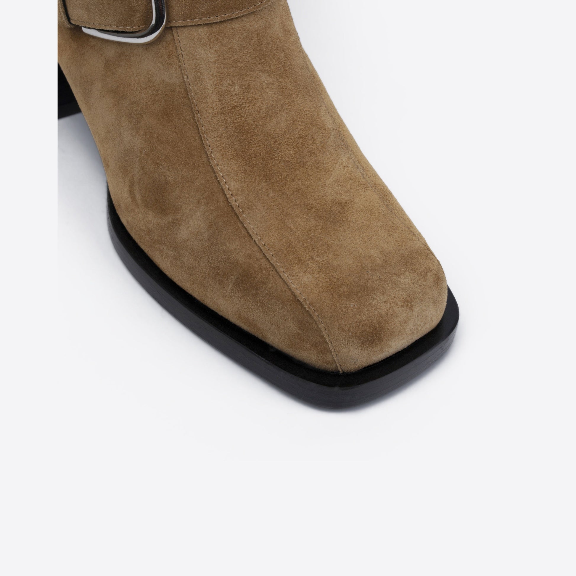 Brown suede boot with a black sole on a white background