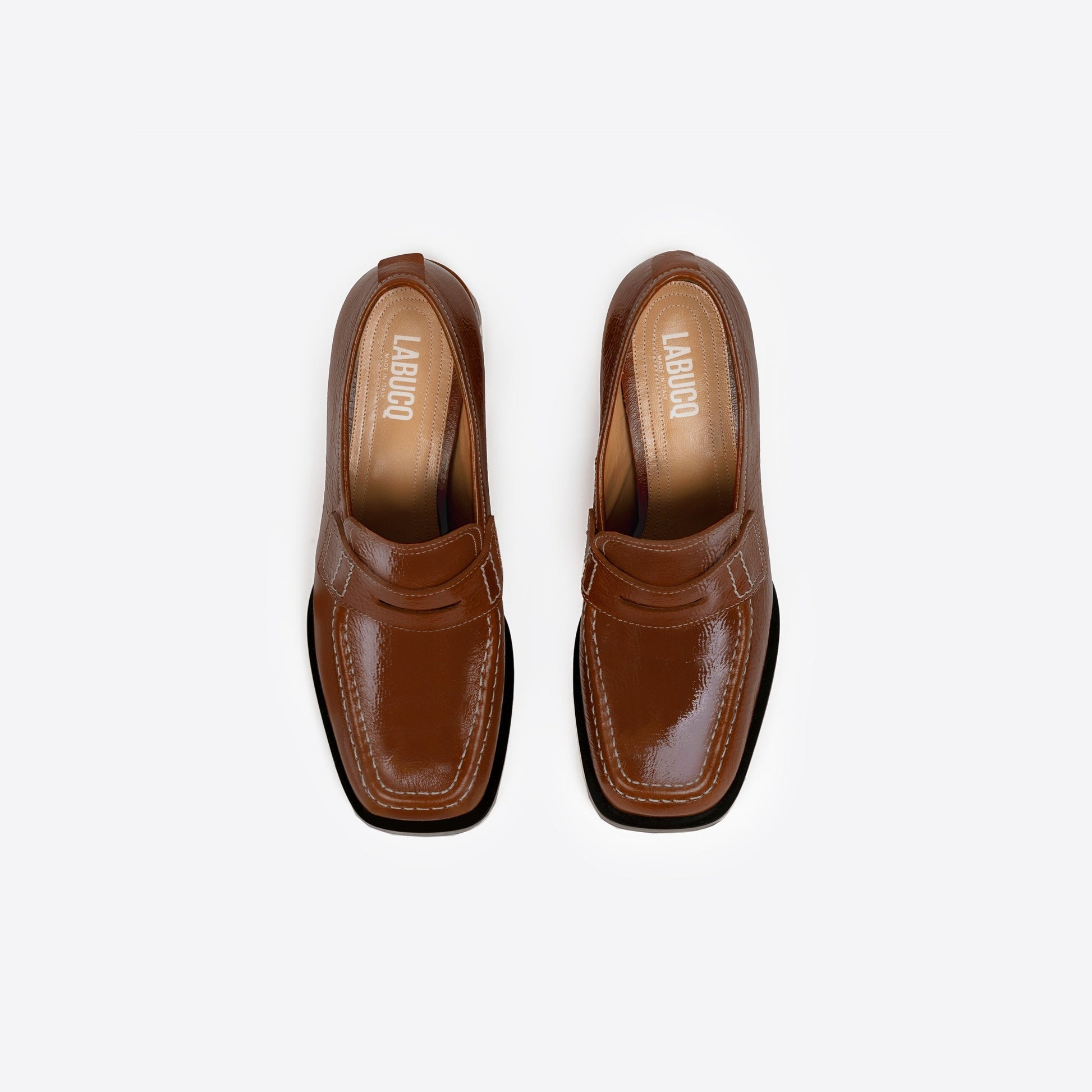 Pair of brown loafers with a 2-inch block heel, black sole, and visible Labucq branding on a white background