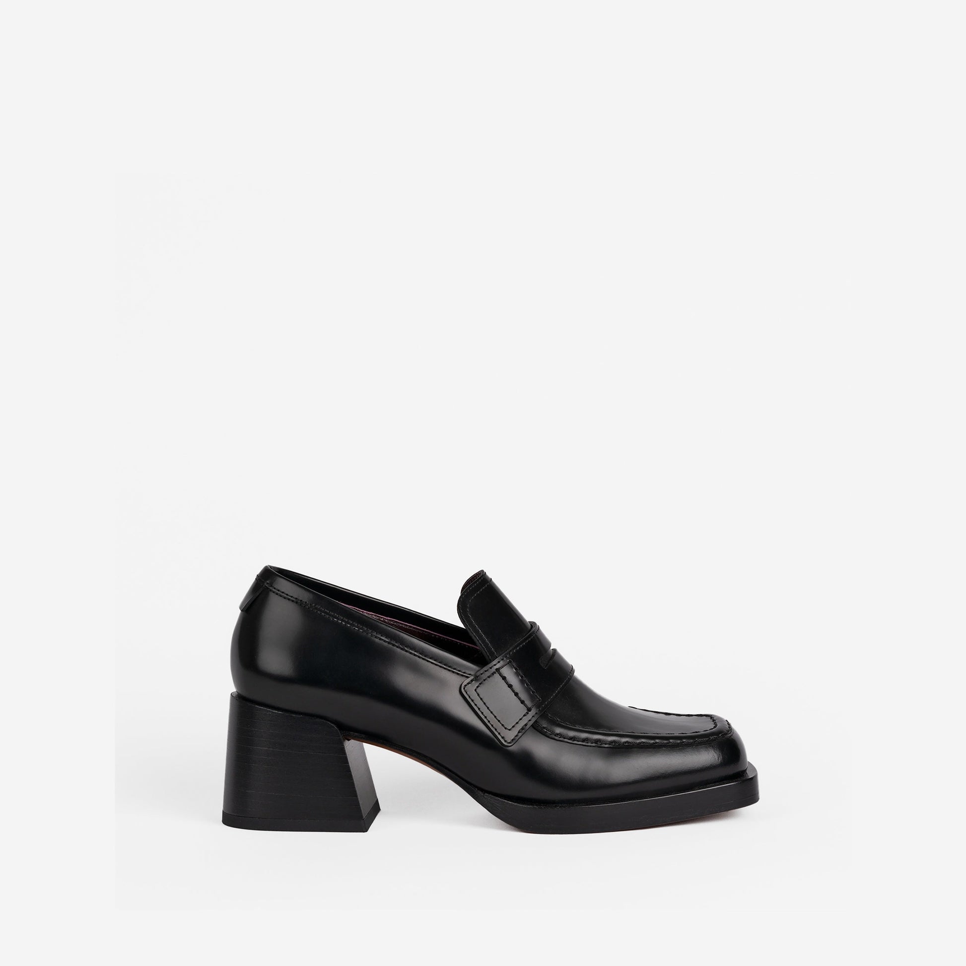 Black loafer with a 2-inch block heel on a white background