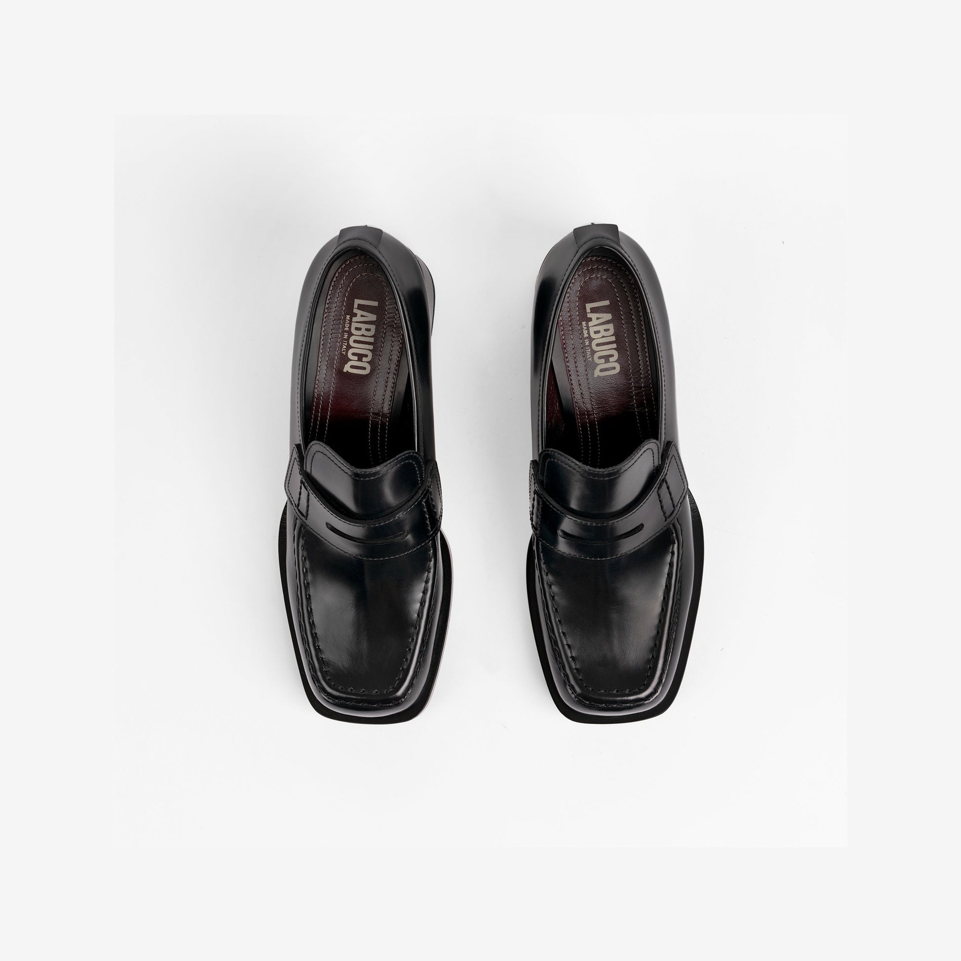 Top view of a black loafer with visible Labucq branding on a white background