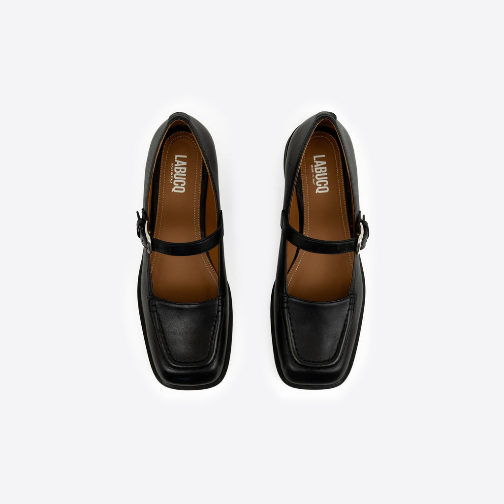 Top-view shot of a pair of black Maryjanes with visible Labucq branding, a black sole, and a buckle on a white background