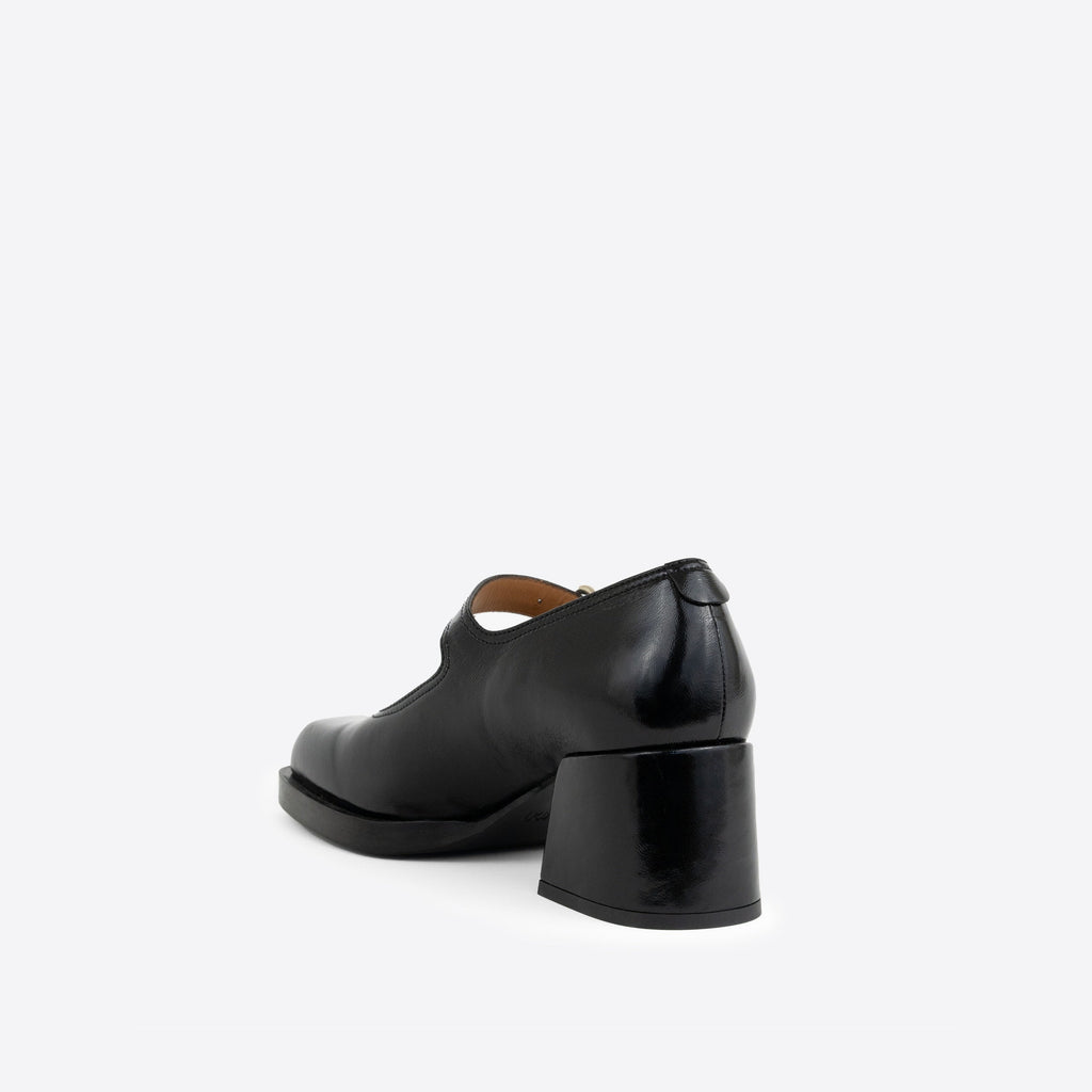 Black patent leather Maryjanes with a 2-inch heel, and a black sole on a white background