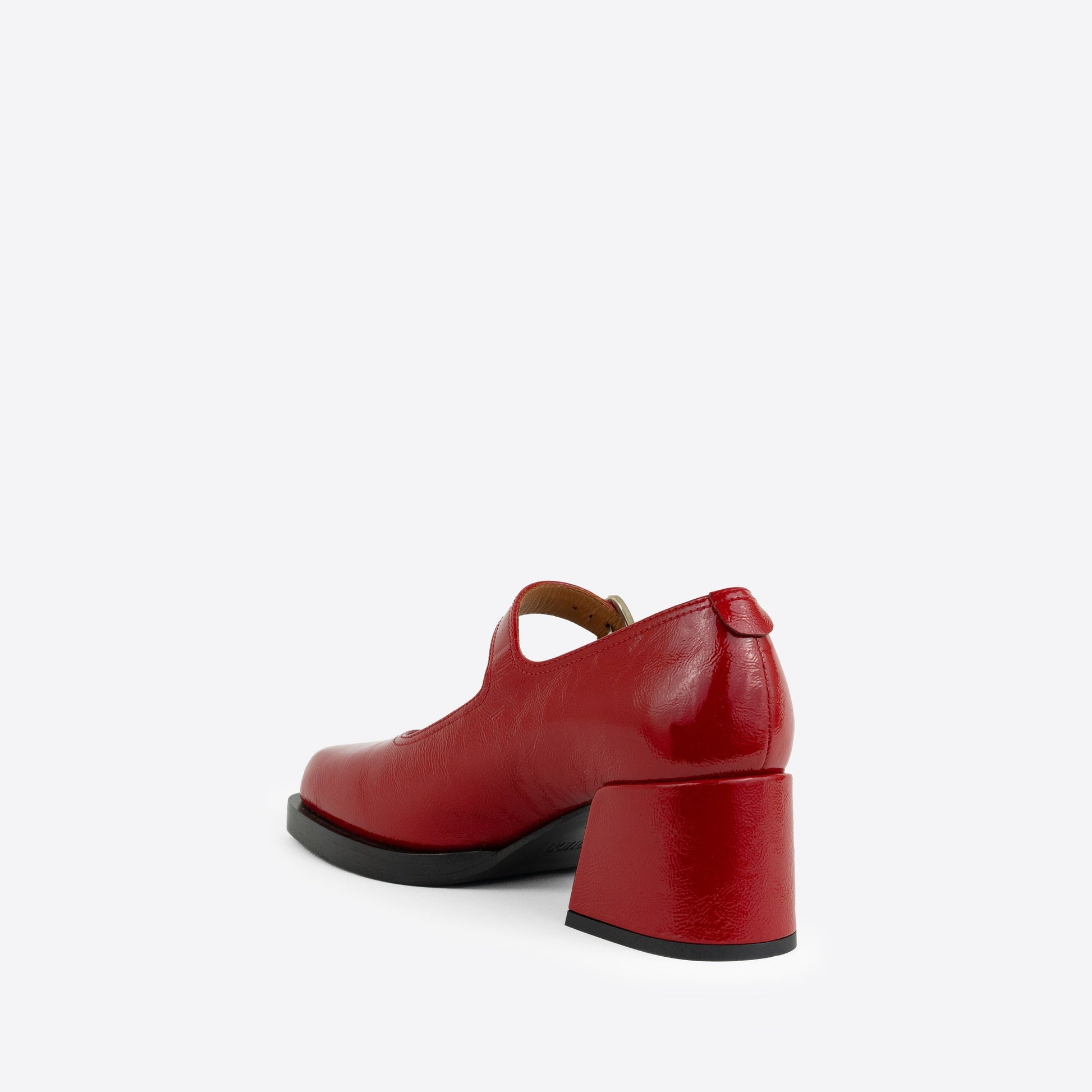 Red patent leather Maryjanes with a buckle, a 2-inch heel, and a black sole on a white background