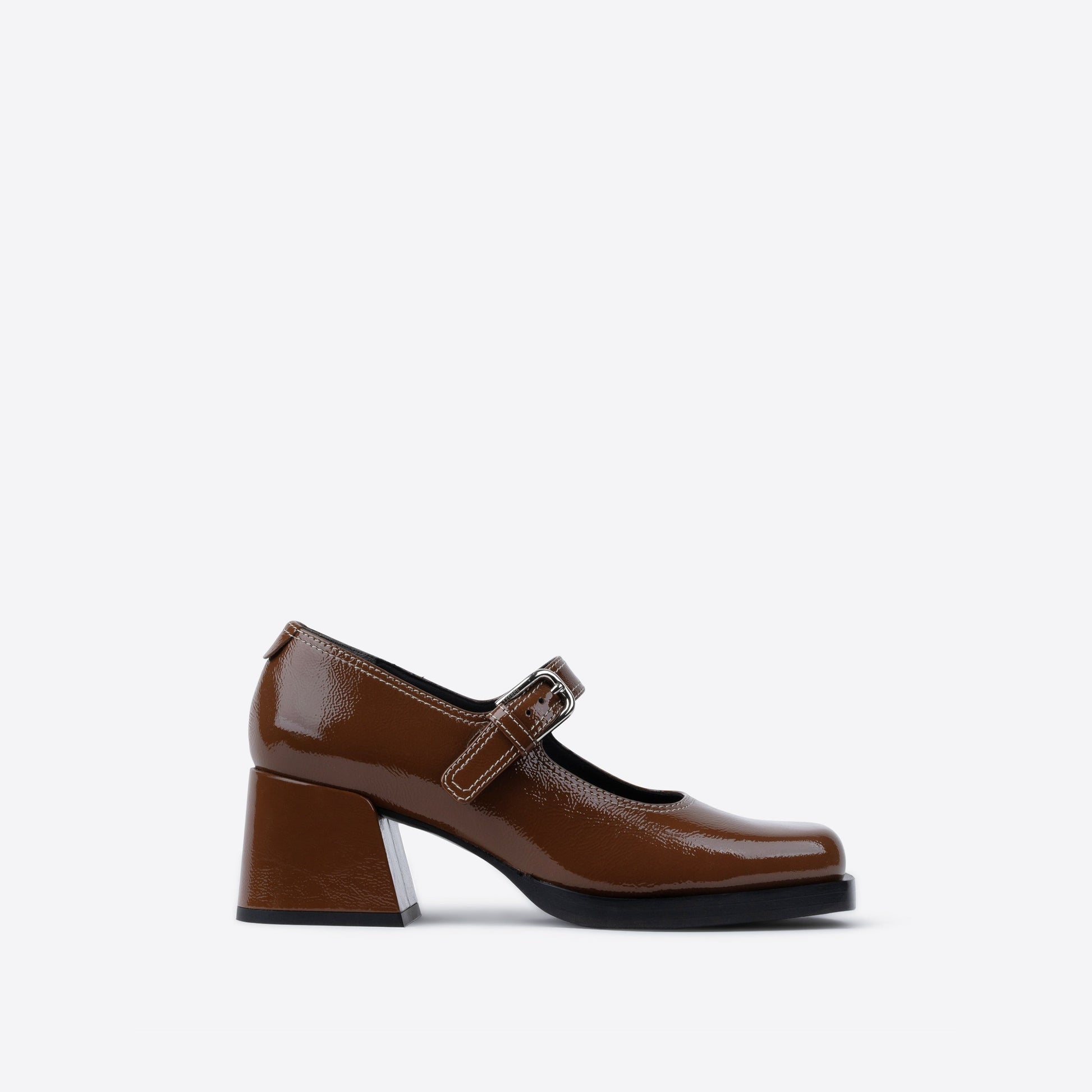 Brown patent leather shoe with a strap on a white background