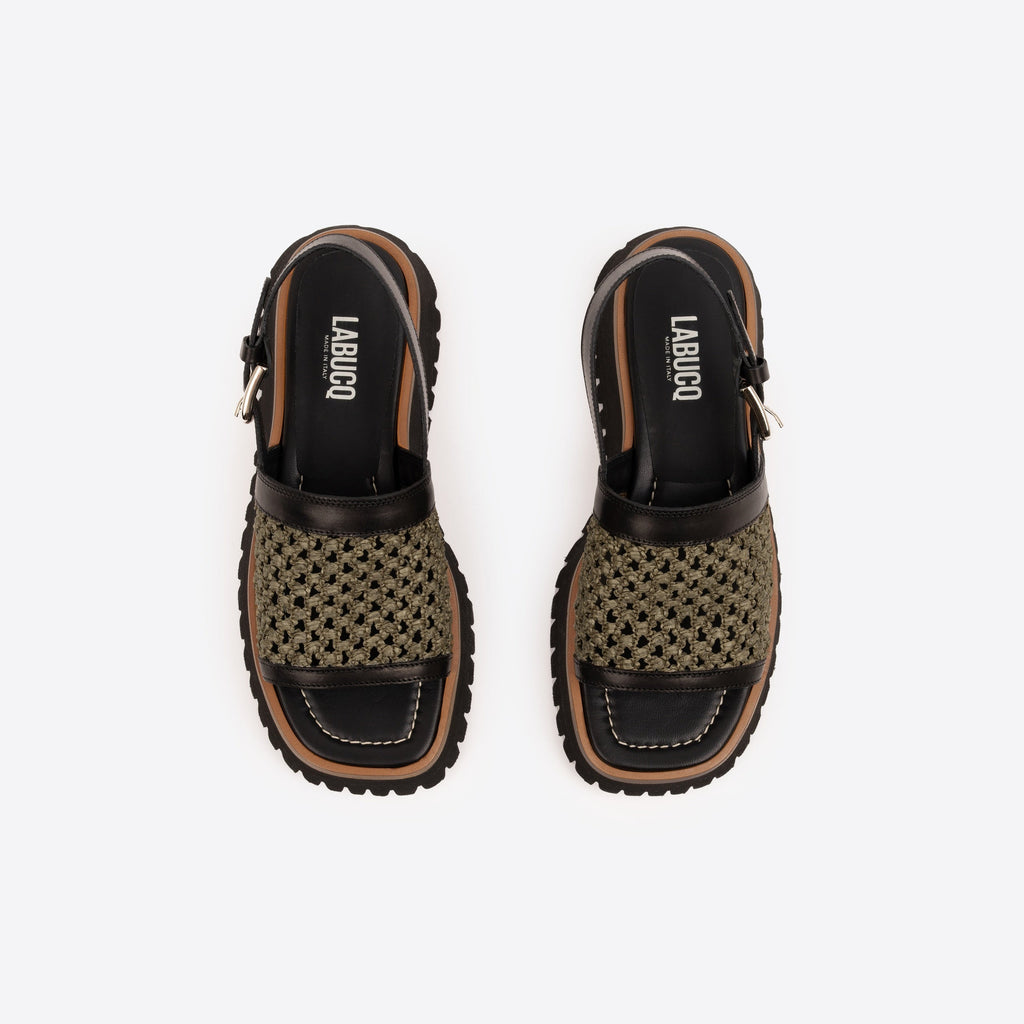 Pair of black platform sandals with brown lining, an olive woven raffia strap, and visible Labucq branding on a white background