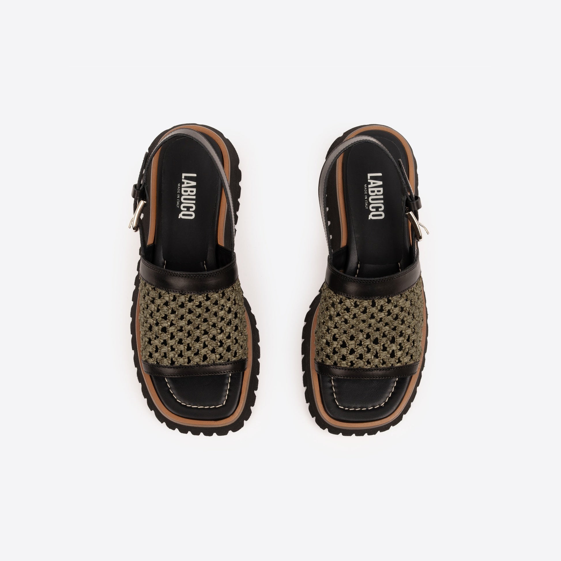 Pair of black platform sandals with brown lining, an olive woven raffia strap, and visible Labucq branding on a white background