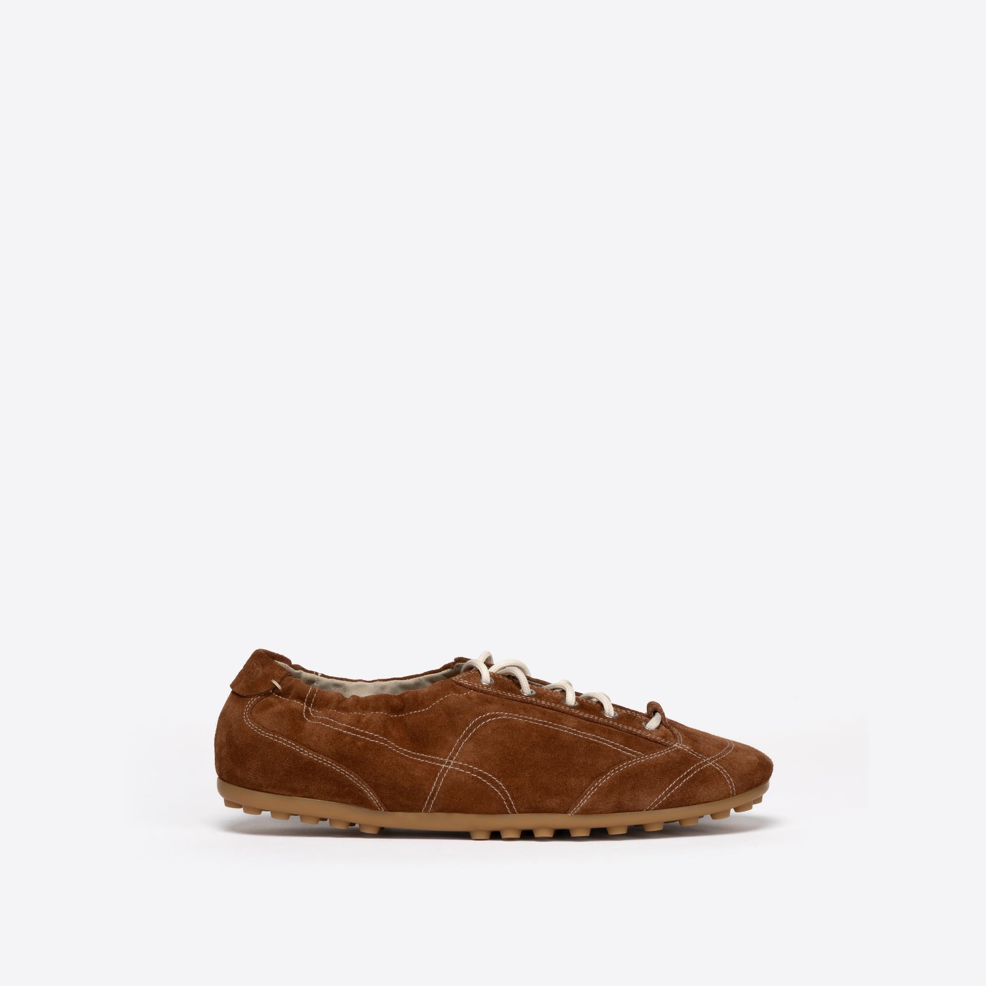 Brown shoe with white laces on a white background
