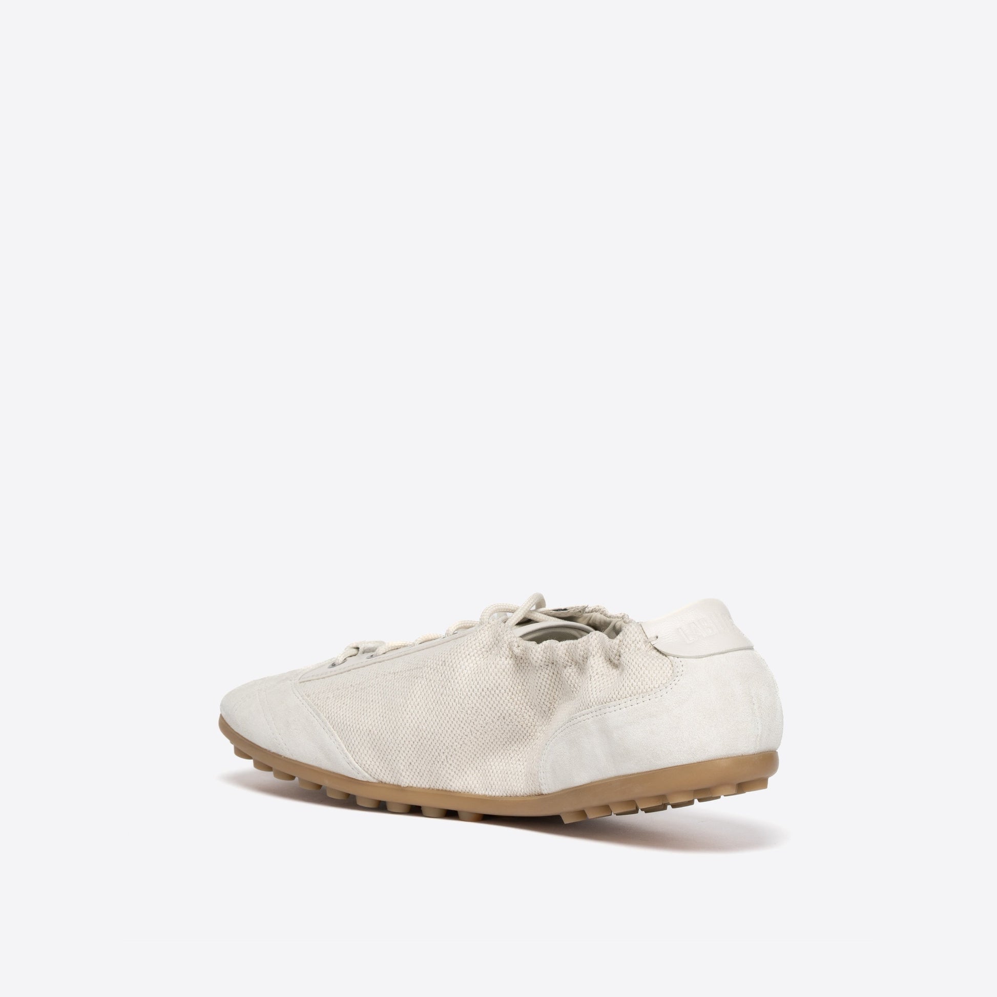 White shoe with light brown sole on a white background