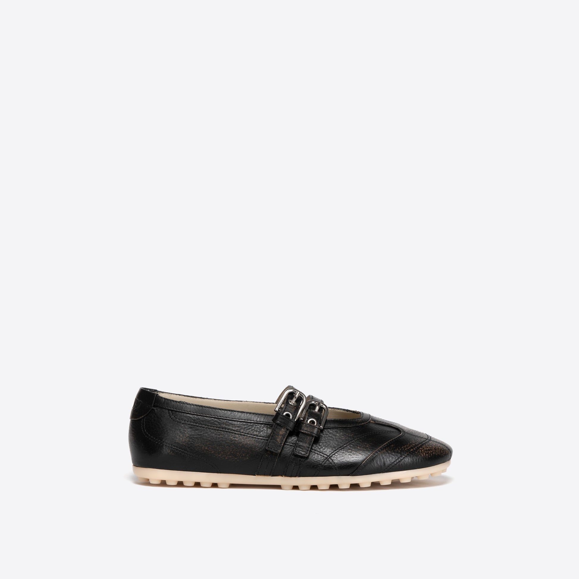 Black Mary Jane with beige outsole with a decorative buckle on a white background