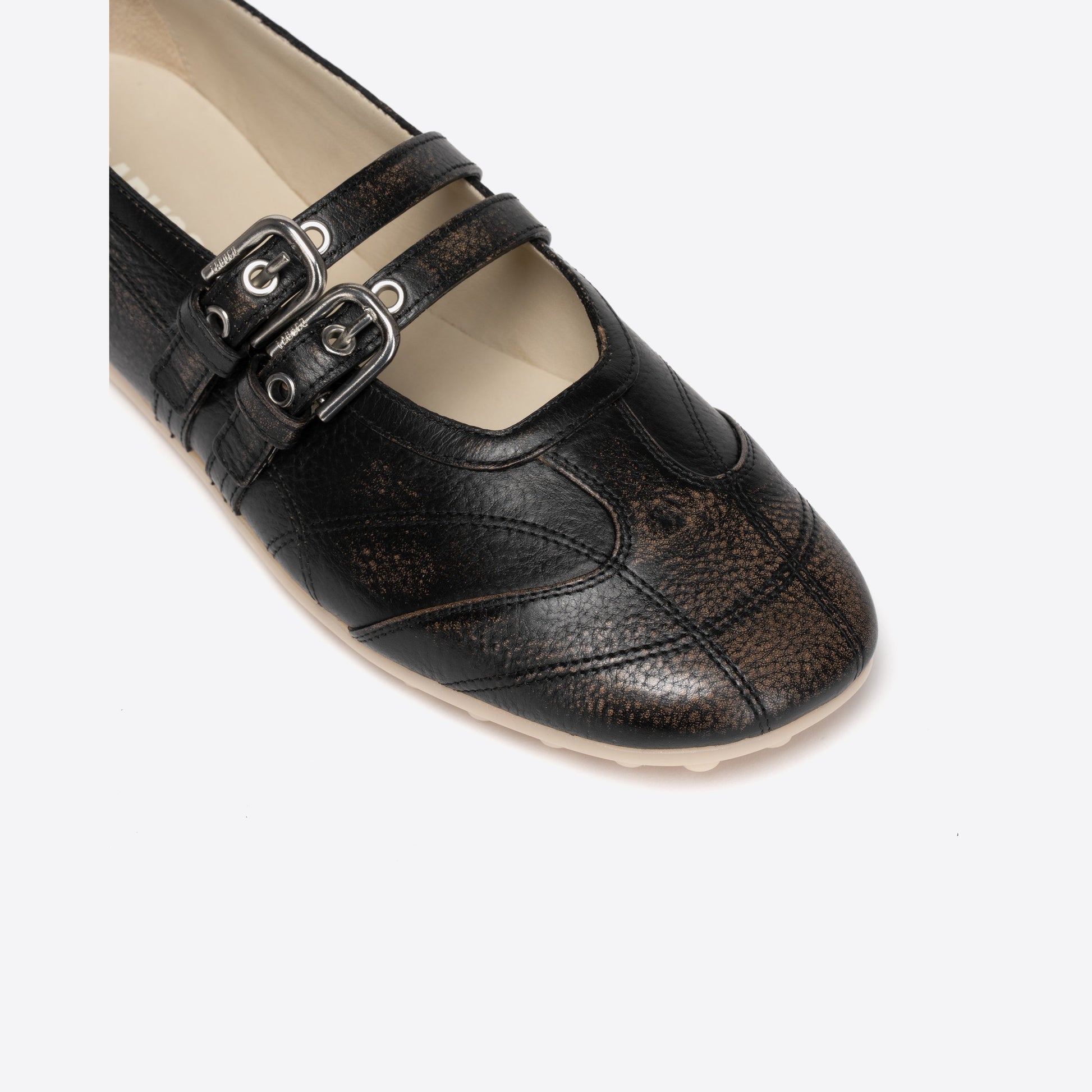 Black Mary Janes with buckles on a white background