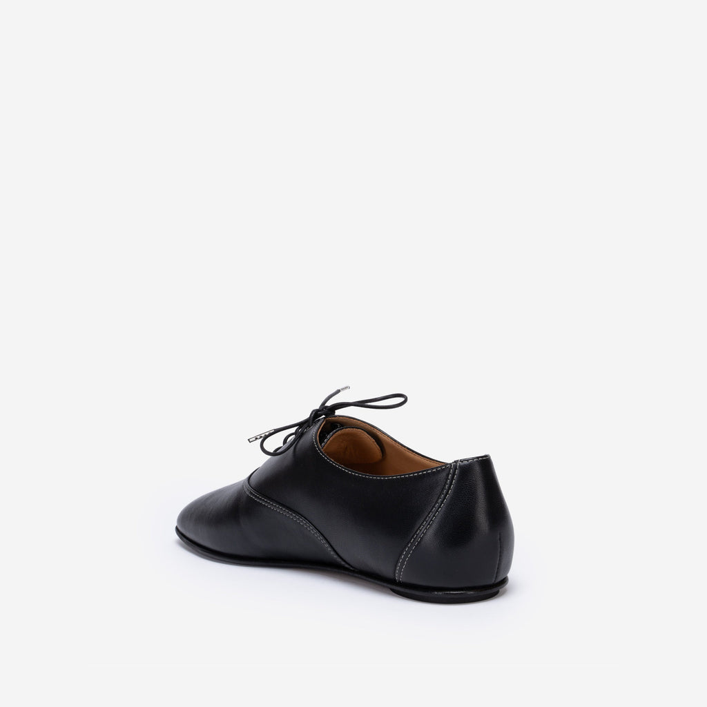 Black leather shoe on a white background