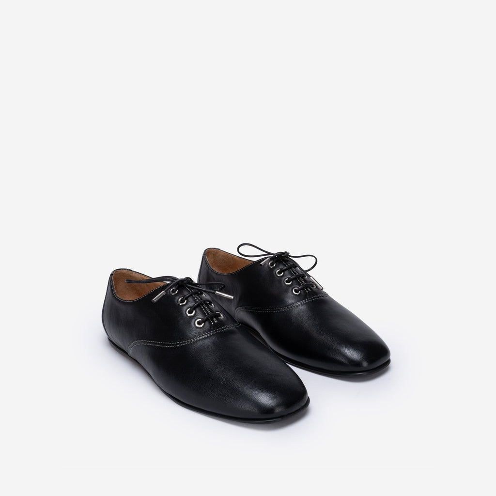 Pair of black leather shoes on a white background