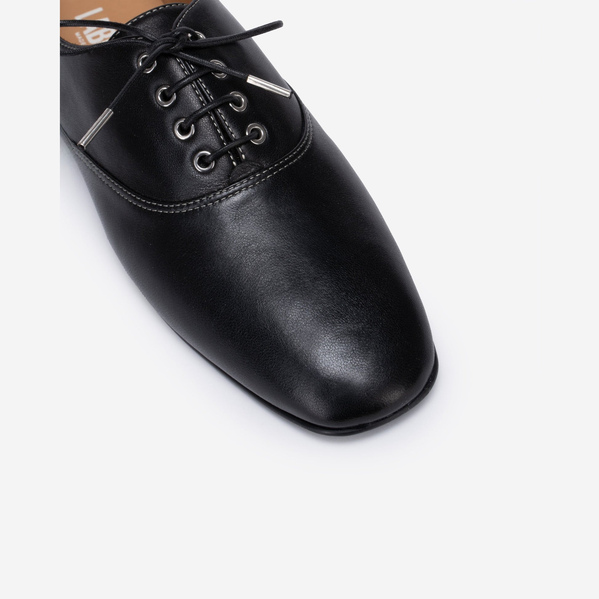 Black leather shoe on a white background