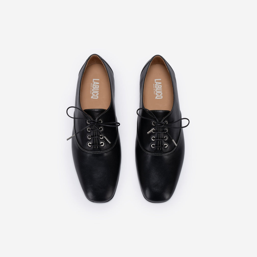 Pair of black leather shoes with 'Labucq' branding on a white background