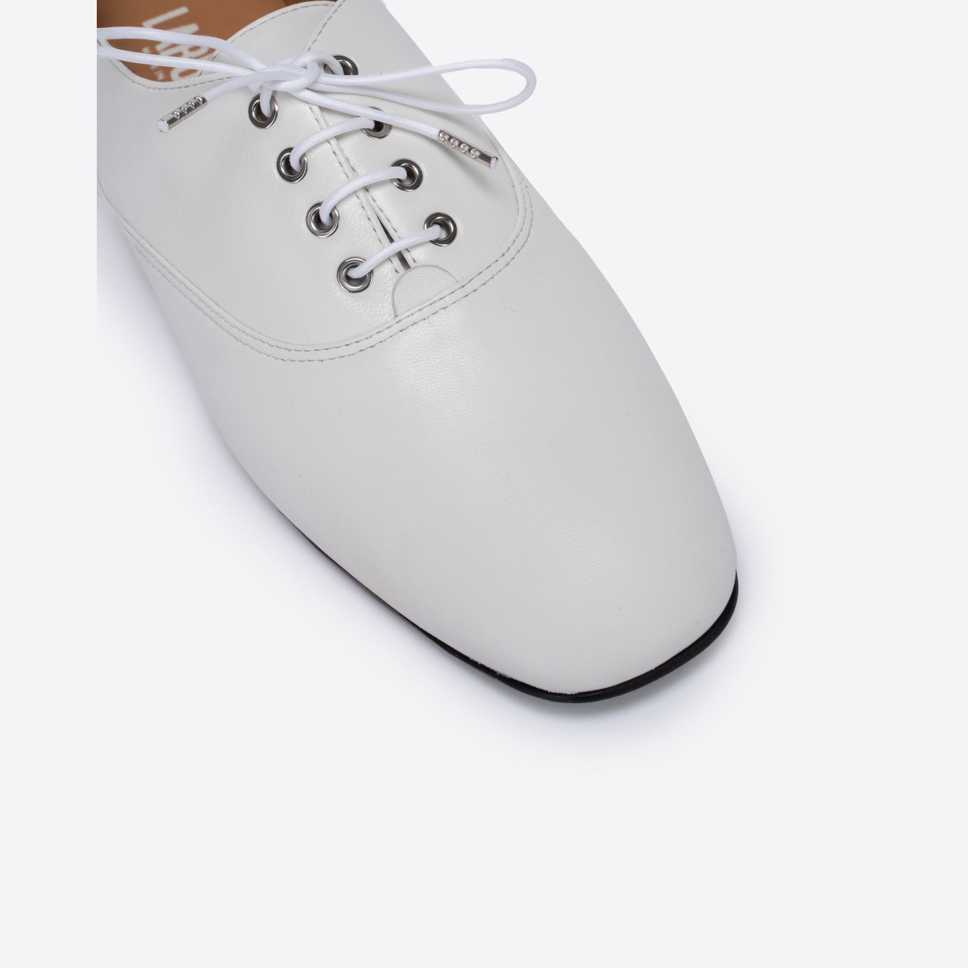White leather shoe with laces on a white background